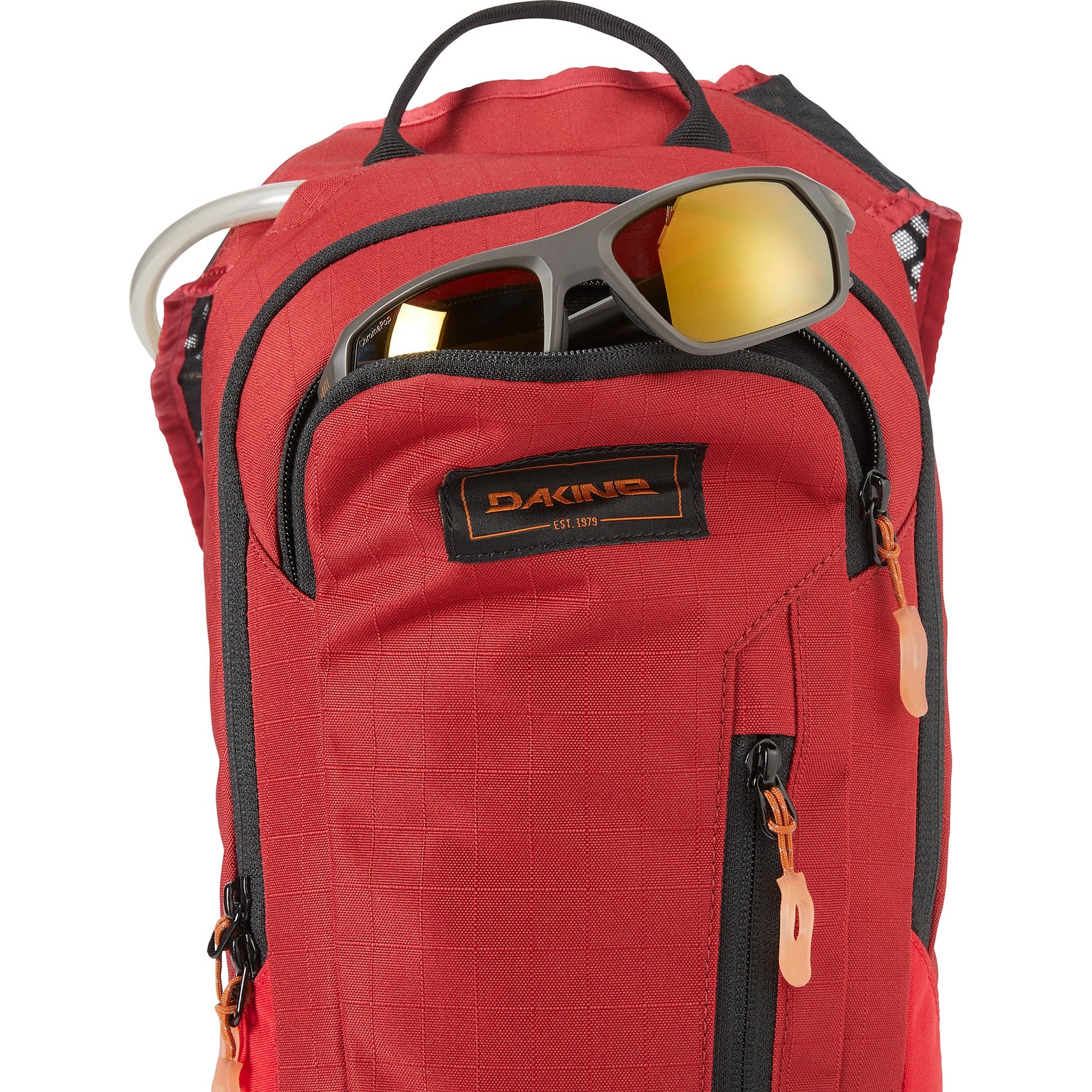 Dakine Shuttle 6L backpack in deep red with sunglasses and water bottle