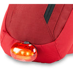 Red Dakine cycling bag with integrated LED safety light attachment
