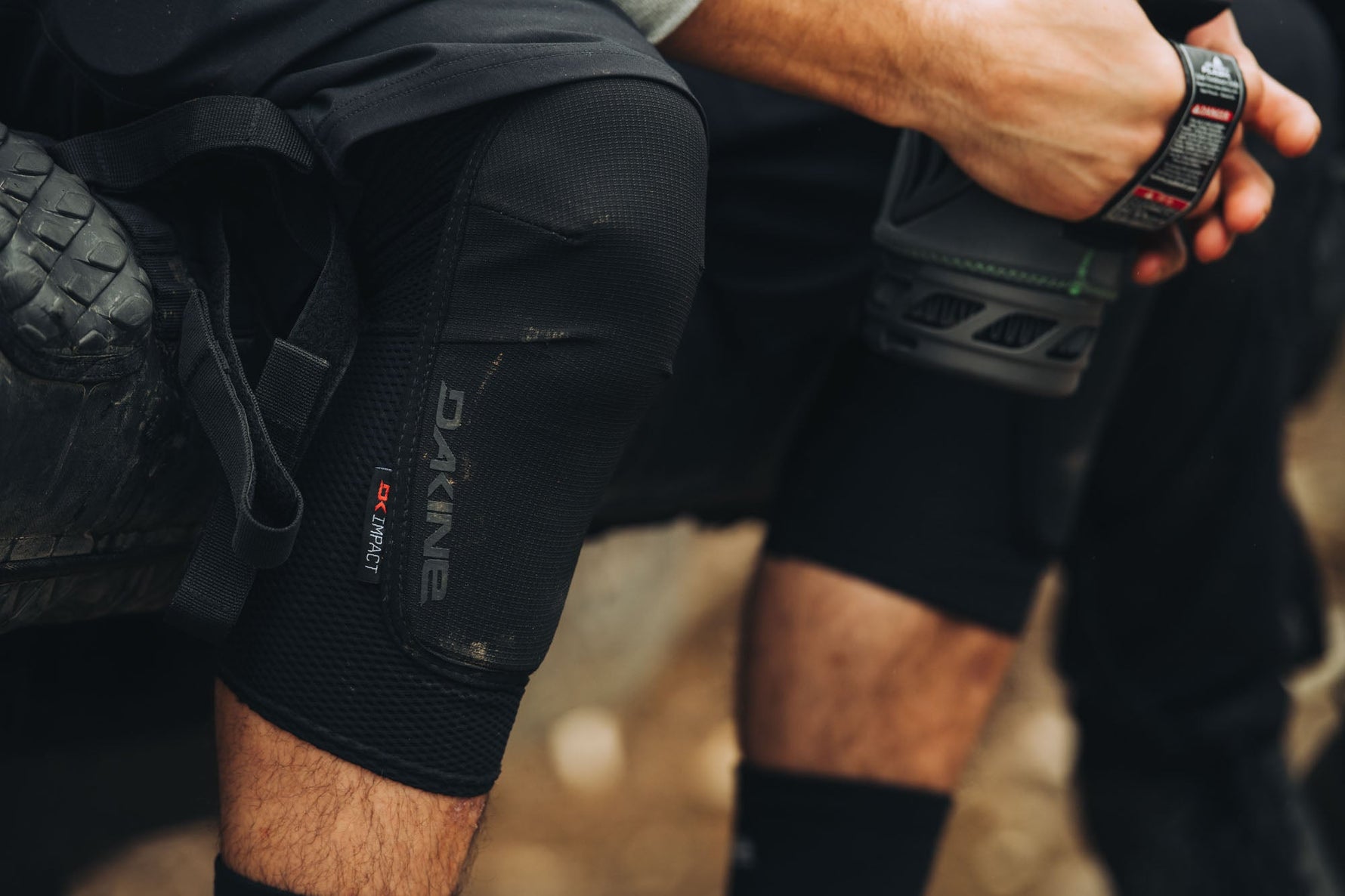 Black Dakine knee sleeve worn during activity showing protective coverage and fit