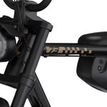 Close-up of black SUPER73 electric bike frame showing tan graphics and handlebars