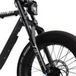 Close-up of SUPER73 electric bike front wheel, fork, and headlight in black