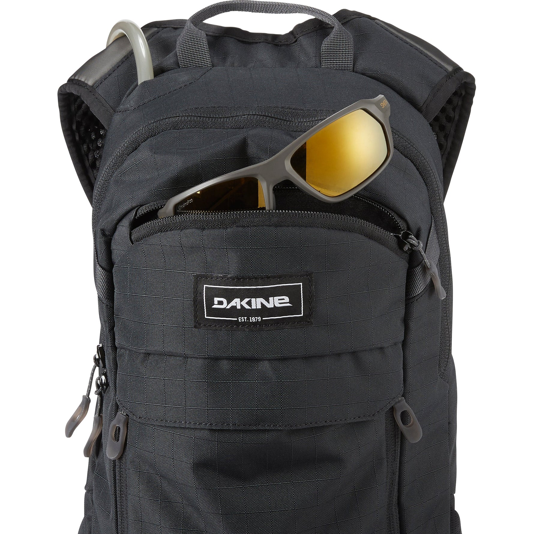 Dakine Syncline 12L black backpack with sunglasses in front pocket on white background