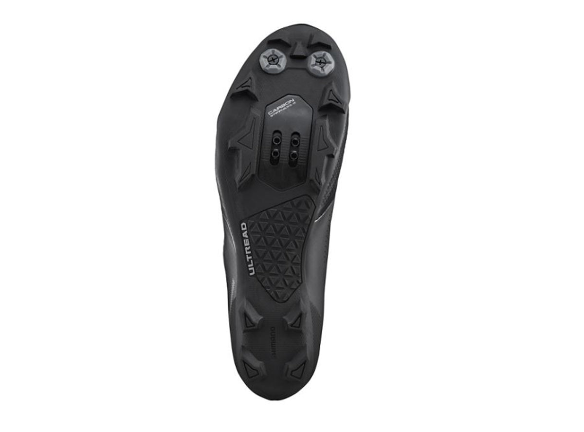 Black Shimano XC702 cycling shoe sole showing cleat mounting and tread pattern