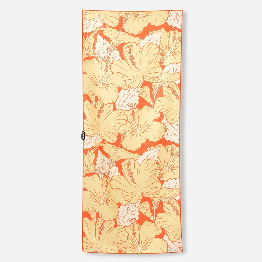 Nomadix fitness towel with orange background and tropical hibiscus flower pattern