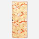 Nomadix fitness towel with orange background and tropical hibiscus flower pattern