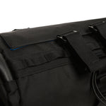 Close-up of black bicycle bar bag showing straps and fabric texture details