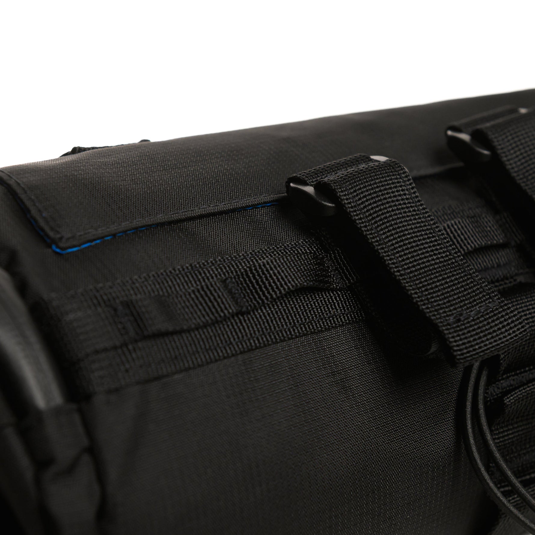 Close-up of black bicycle bar bag showing straps and fabric texture details