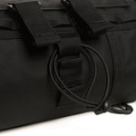 Close-up of black tactical bag showing D-ring hardware and webbing straps