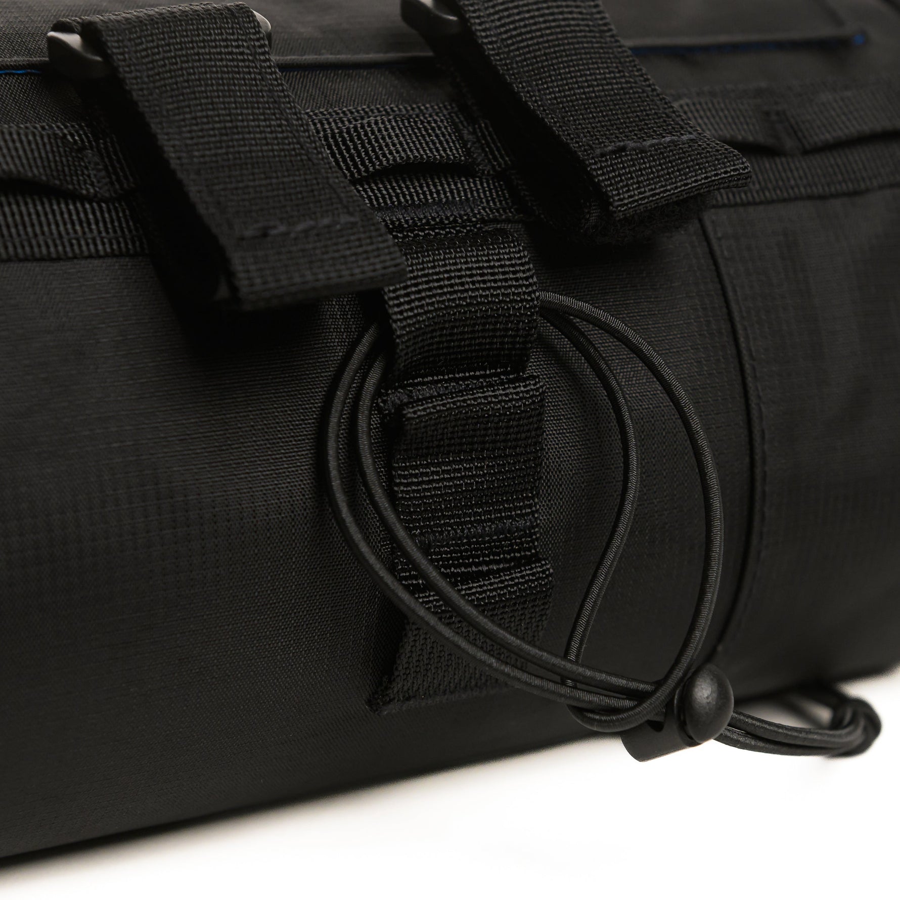 Close-up of black tactical bag showing D-ring hardware and webbing straps