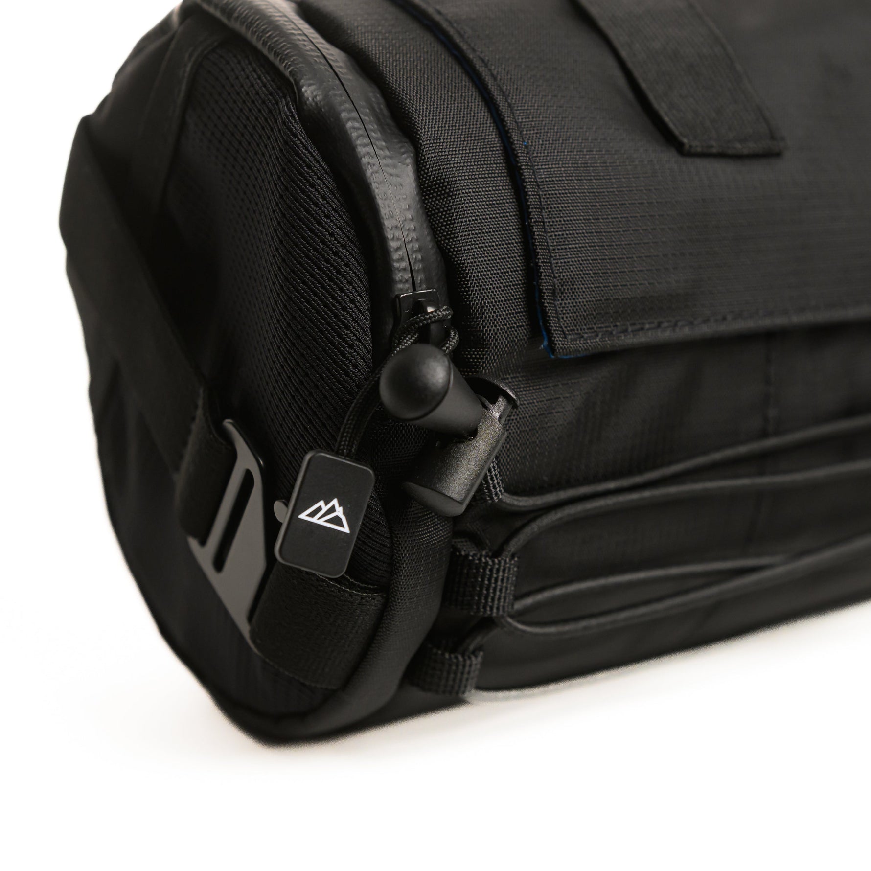 Close-up of black Almsthre bar bag showing zipper pull and mountain logo detail