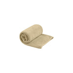 Sea To Summit Tek Towel in desert brown, partially rolled on white background
