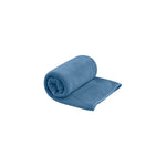 Sea To Summit Tek Towel in blue microfiber material, partially rolled