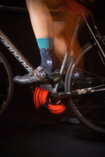 Taba Legg T cycling socks in navy blue and turquoise worn with Sidi cycling shoes on Cannondale bike