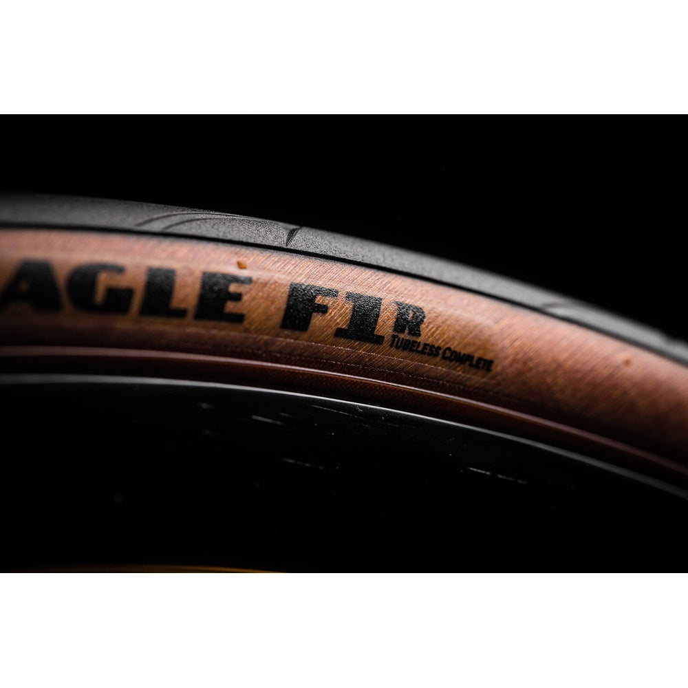 Goodyear Eagle F1R bicycle tire close-up showing black tread and brown sidewall