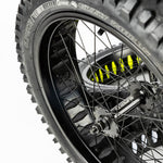 Super73 yellow wheel liner installed on black spoked bicycle wheel