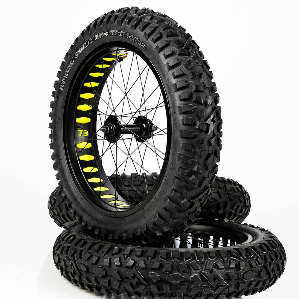 Super73 yellow wheel liner installed on fat bike wheels with knobby tires