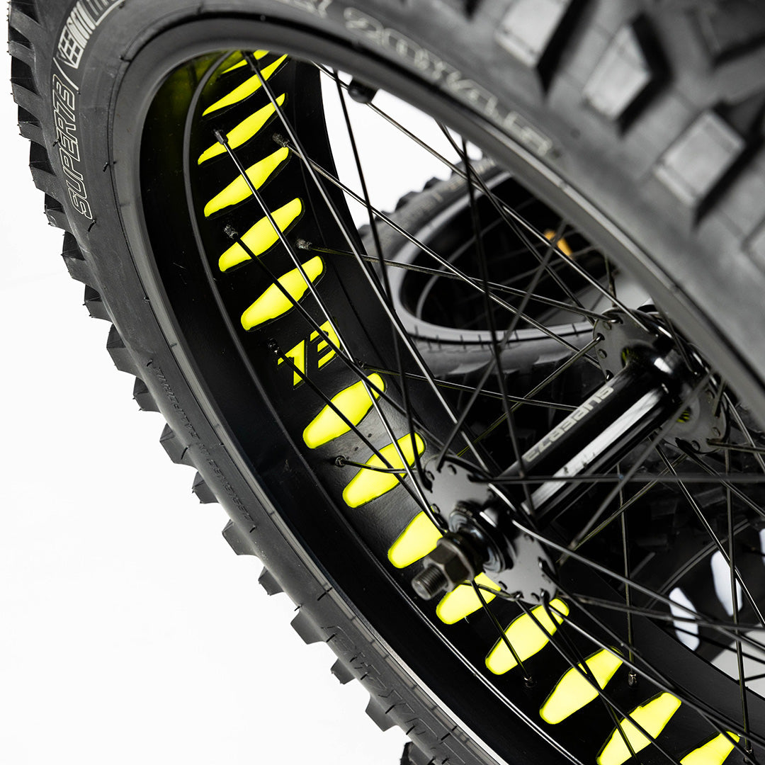 Super73 yellow wheel liner installed on black bicycle wheel with spokes