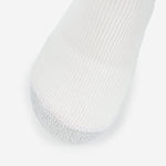 Thorlos white tennis sock with gray reinforced toe cushioning on clean background