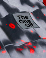 Close-up detail of TheOneOff brand logo badge on Krypton jersey with red pixel pattern