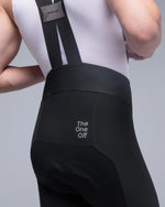 Close-up rear view of TheOneOff Xenon Bib Short in Future Black worn by male model