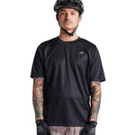Troy Lee Designs Flowline Short Sleeve Jersey in solid black on male model
