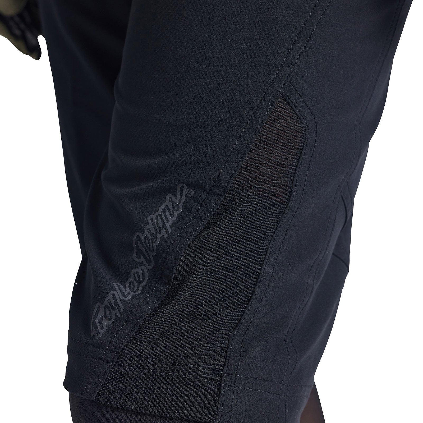 Close-up of Troy Lee Designs black cycling shorts showing knee padding detail