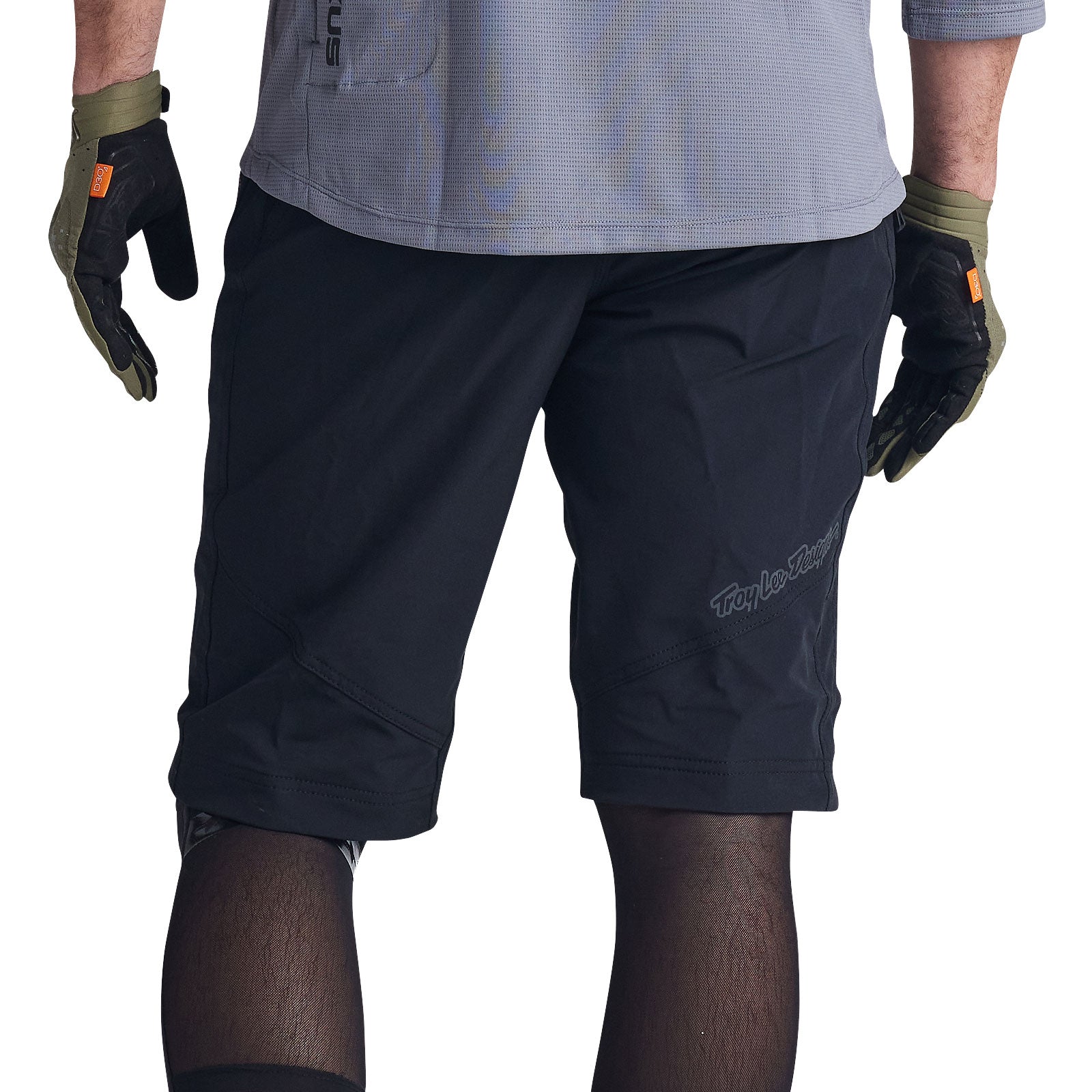 Man wearing black Troy Lee Designs Ruckus cycling shorts with matching gloves