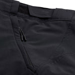 Close-up of black Troy Lee Designs cycling shorts showing pocket detail and stitching