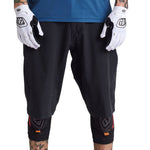 Troy Lee Designs black cycling shorts with liner on model wearing white gloves