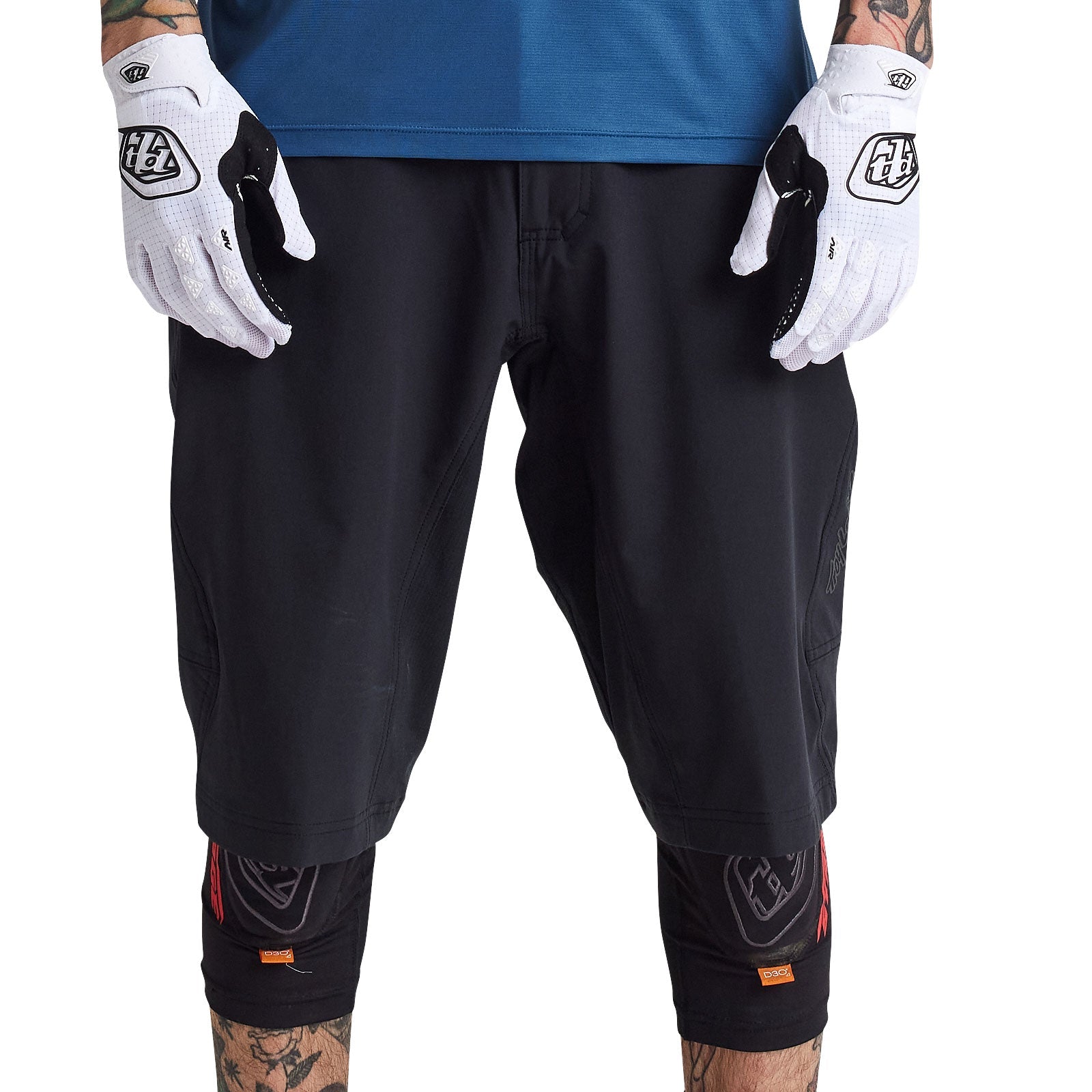 Troy Lee Designs black cycling shorts with liner on model wearing white gloves
