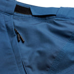 Close-up detail of blue Troy Lee Designs Skyline shorts showing fabric texture and construction