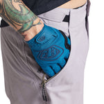 Troy Lee Designs Skyline shorts in charcoal with blue knee pad showing TLD logo