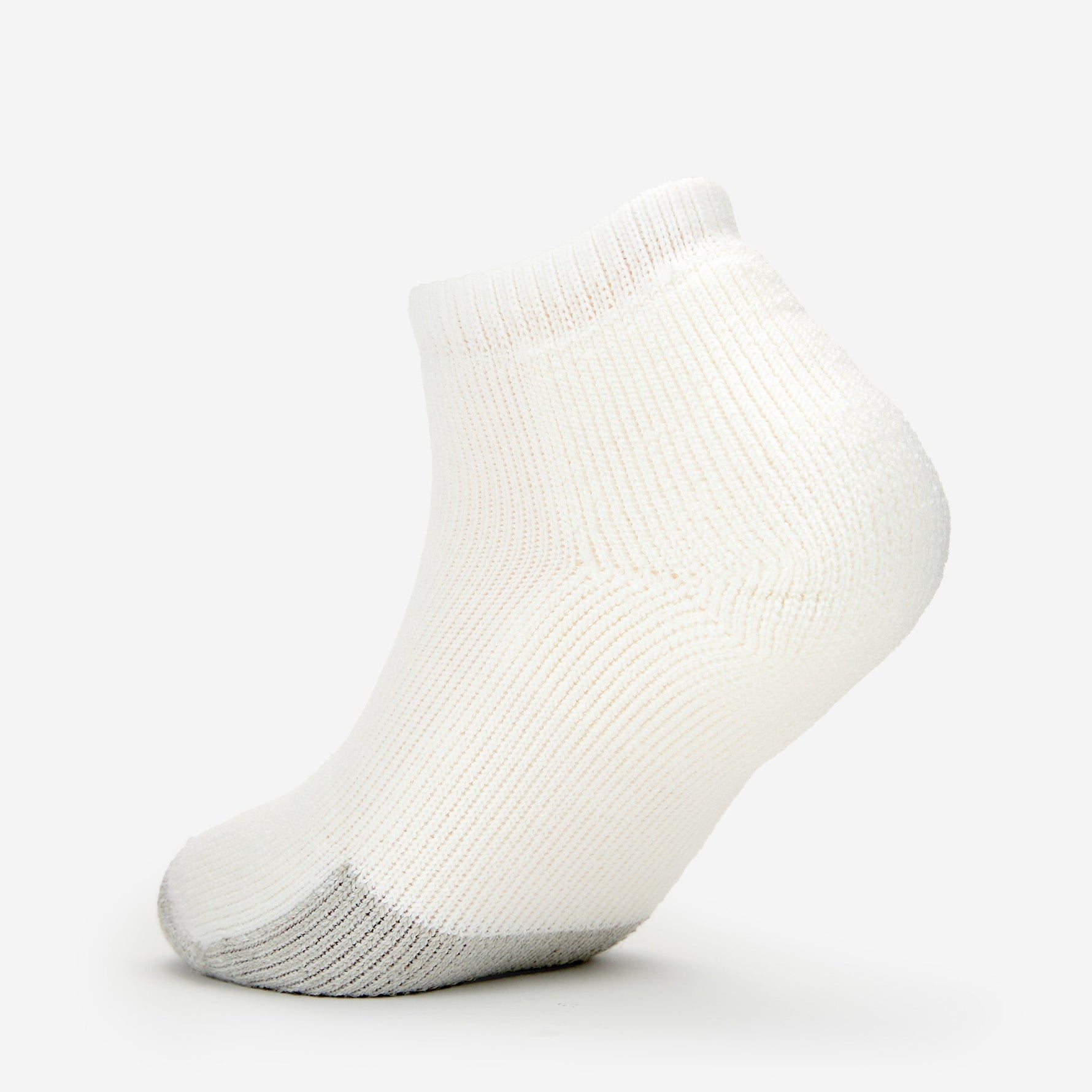 Thorlos white low cut tennis sock with gray heel cushioning on clean background