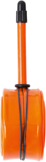 Orange Tubolito road bike tube with black valve stem on white background