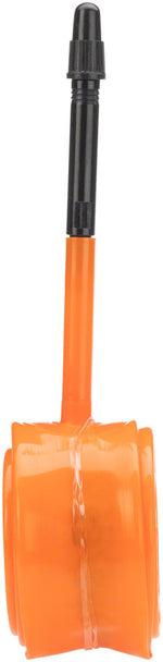 Orange Tubolito bicycle tube with black valve stem against white background