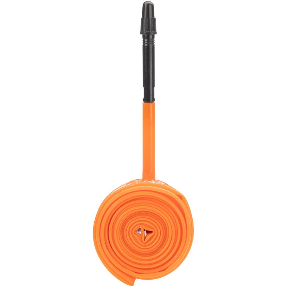 Orange Tubolito bicycle inner tube with black valve stem, coiled and displayed vertically