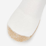Thorlos white tennis crew sock with gold cushioned toe reinforcement close-up view