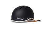 Thousand JR Kids bicycle helmet in matte carbon black with white trim and brown leather strap