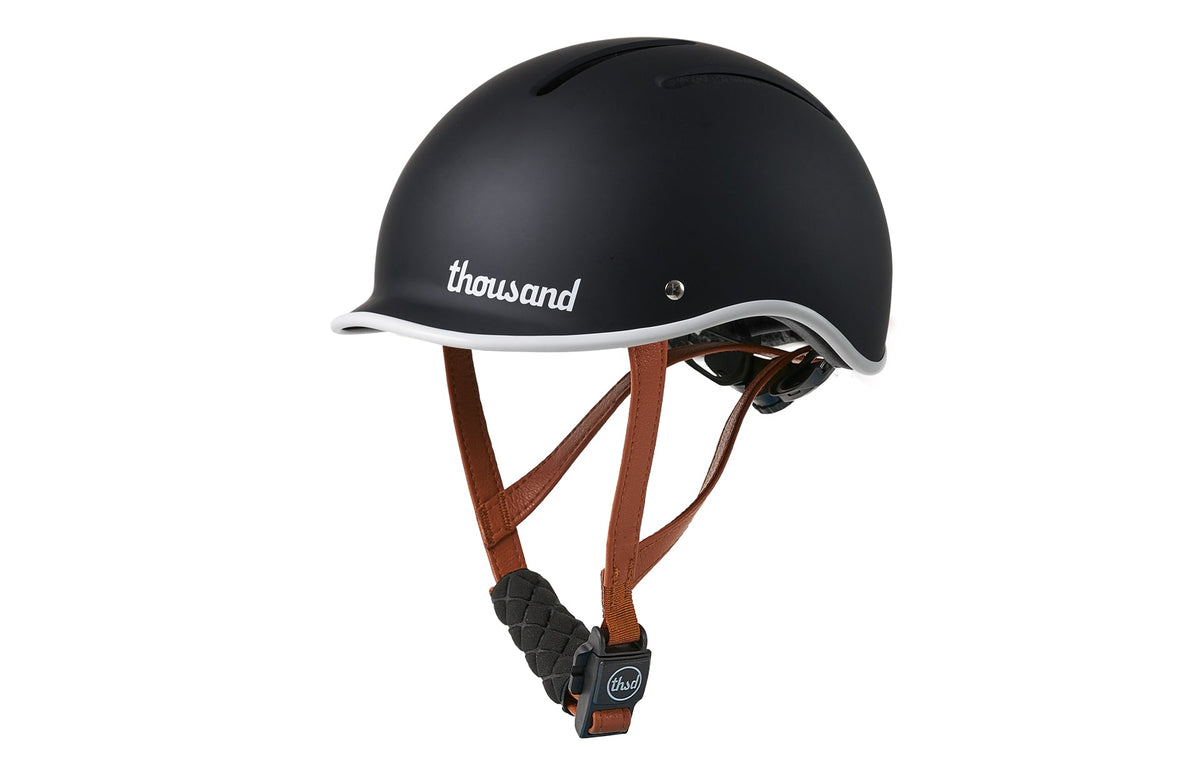 Thousand JR Kids helmet in carbon black with brown leather straps and white brim trim