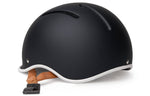 Thousand JR Kids Helmet in matte carbon black with white trim and tan leather straps