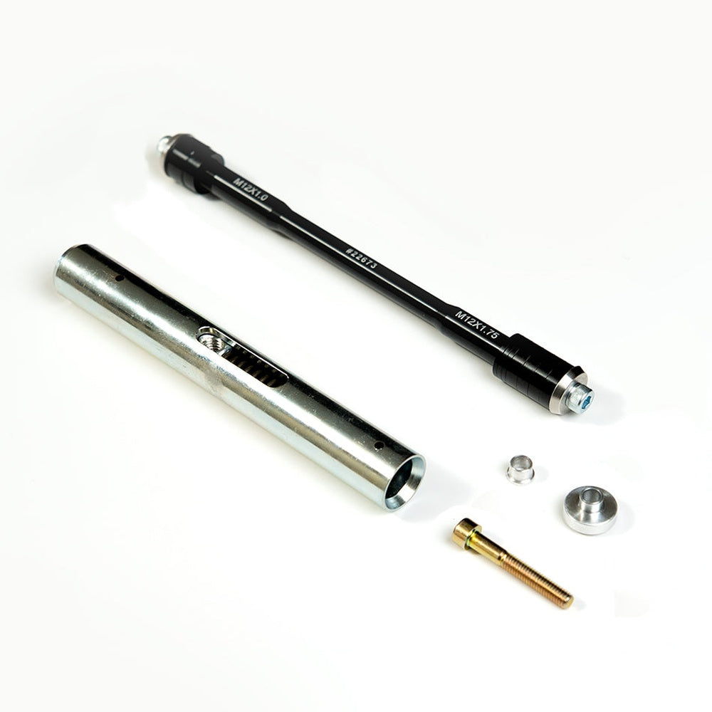 Saris thru axle adapter components including silver outer tube, black inner rod, and hardware