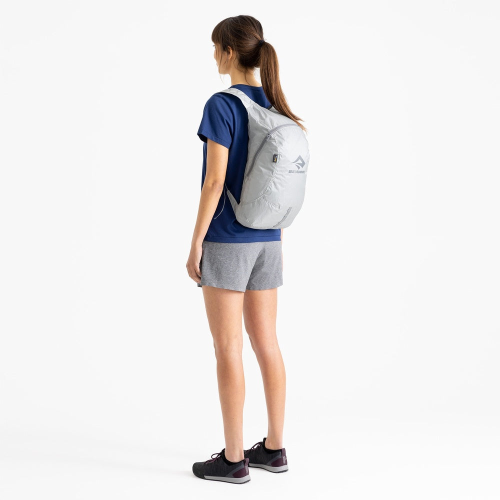 Woman wearing Sea To Summit Ultra-Sil Day Pack in light grey, back view