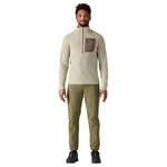 Man wearing Patagonia R1 Air Fleece zip-neck in pelican color with olive pants