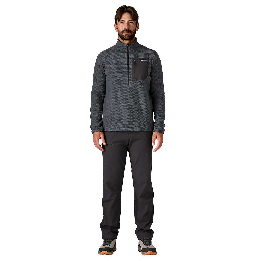 Man wearing Patagonia R1 Air Zip-Neck fleece in smolder blue with black pants
