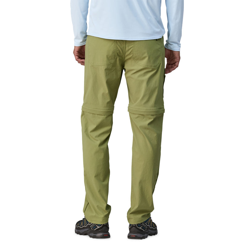 Back view of man wearing Patagonia Quandary convertible pants in olive green color