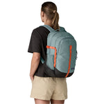 Woman wearing Patagonia Refugio Day Pack 26L in Blue Sage color from behind