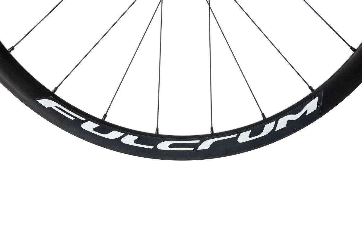 Close-up of Fulcrum wheel rim showing full brand name lettering on black carbon rim