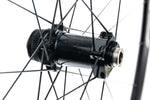 Close-up of Fulcrum disc brake front hub showing thru-axle end cap and spoke lacing detail