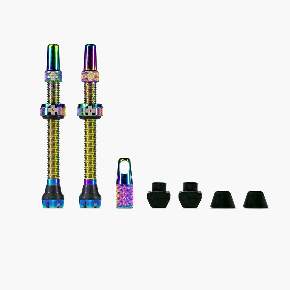 Muc-Off tubeless valve kit with iridescent rainbow finish and black rubber seals