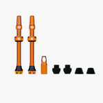 Muc-Off V2 Tubeless Valve Kit in orange iridescent finish with valve stems and accessories
